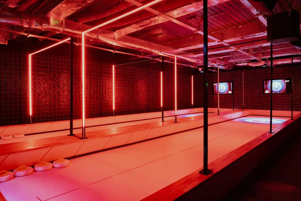 Crazy Pool room with neon red lighting, black support poles, and interactive floor displays.
