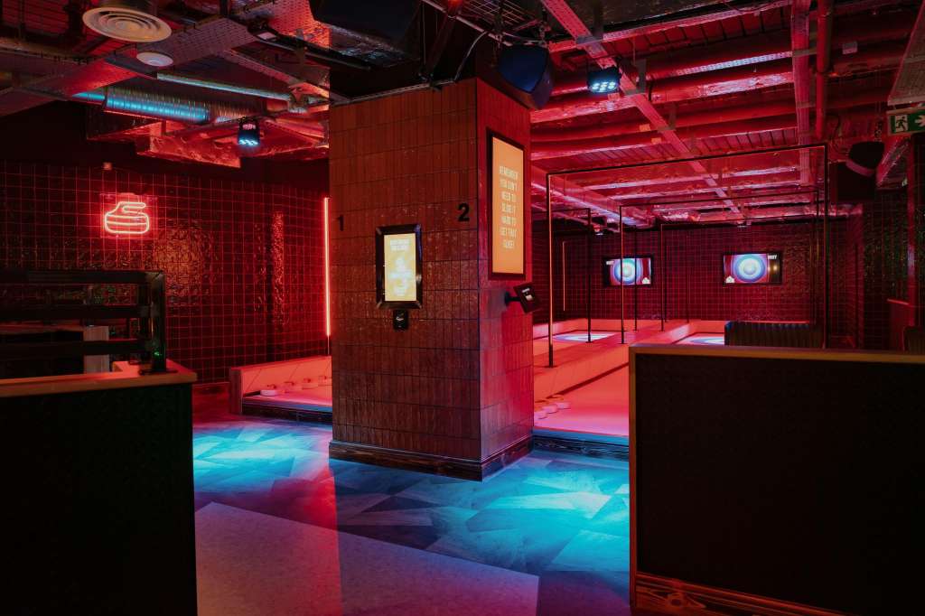 Crazy Pool room with neon red lighting, tiled walls, illuminated floor, and pool tables visible in background.