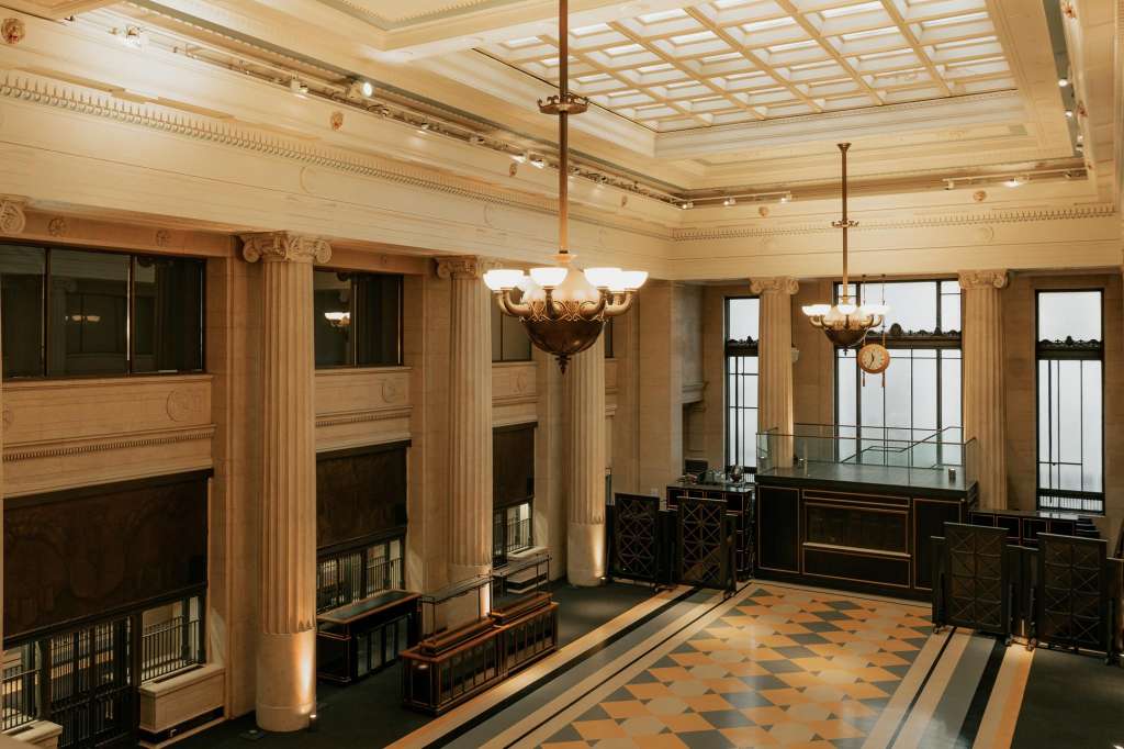 Main Hall with coffered ceiling, ornate columns, fireplaces, pendant lighting, and geometric floor pattern.
