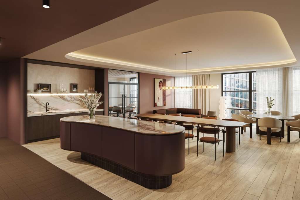 Modern open-plan space with kitchen island, dining table, and lounge seating. Curved ceiling with ambient lighting and floor-to-ceiling windows.
