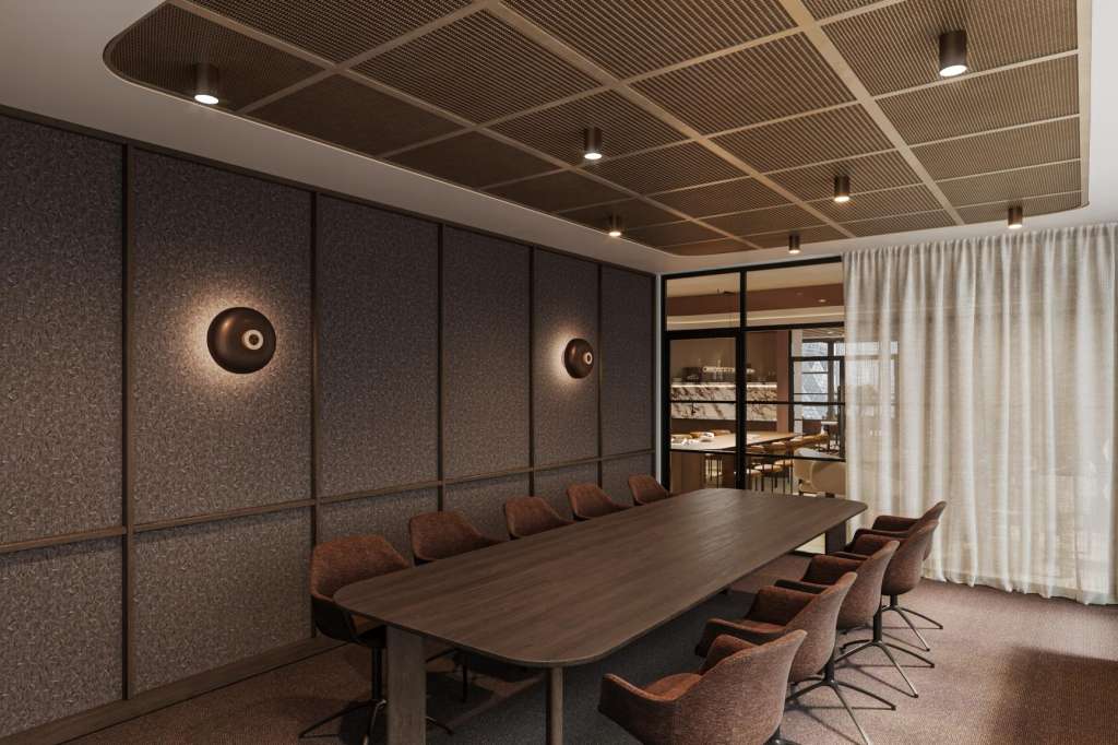Discovery Project Space with long wooden table, brown leather chairs, textured wall panels, and modern ceiling lighting.